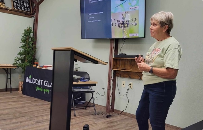 Woman giving an educational presentation about dragonflies and damselflies at a Wildcat Glades Friends Group event.